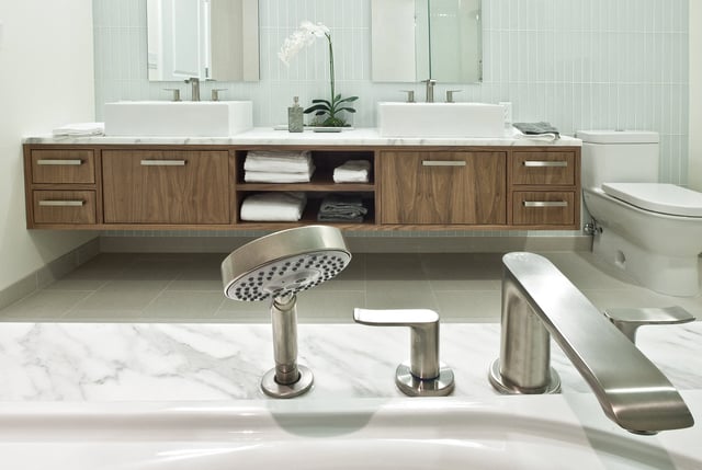 Modern bathroom vanity with dual sinks, wood cabinetry, and sleek faucets.