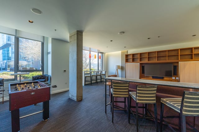 Community lounge with foosball table and bar seating.