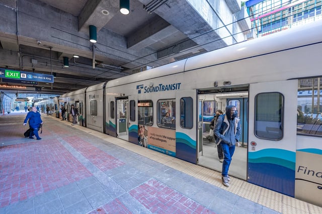 Sound Transit train at an underground station platform with people boarding and disembarking.