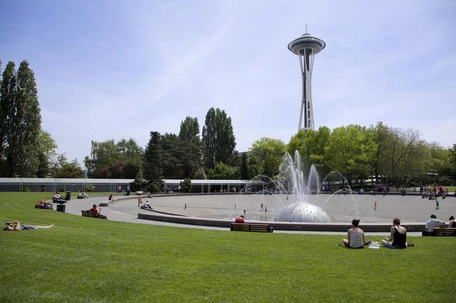 Large park with a fountain and the Space Needle in the background.