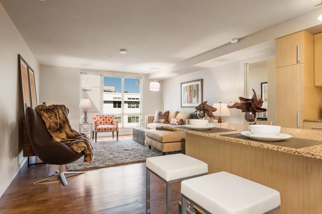 Living room with large window and modern furniture.