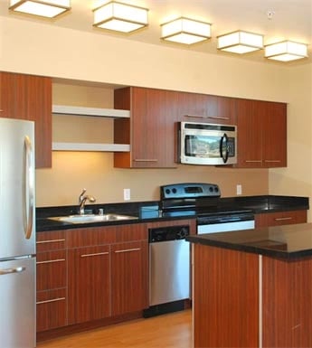 Modern kitchen with stainless steel appliances and wooden cabinets
