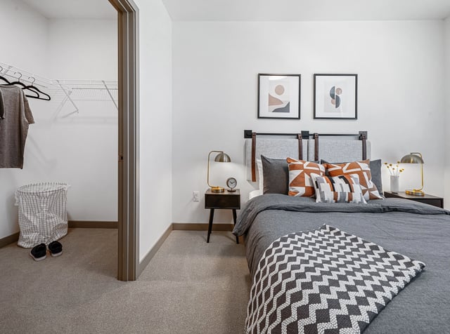 Bedroom with a large bed, nightstands, and a walk-in closet.