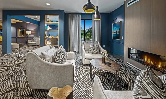 Modern lounge area with comfortable seating and a fireplace.