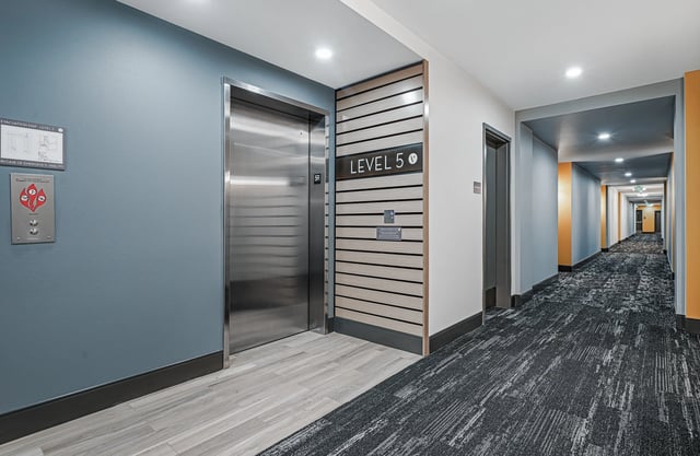 Hallway with elevators and doors on Level 5
