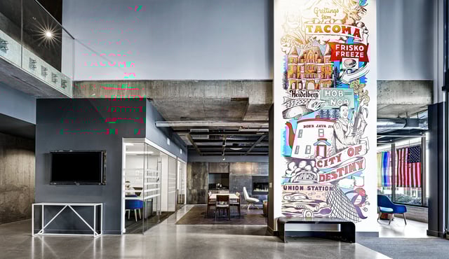 Interior common area with a large mural and seating areas.