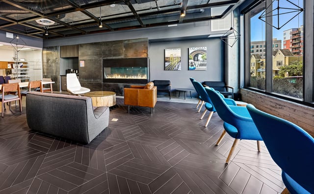 Modern lounge area with fireplace and large windows overlooking the city.