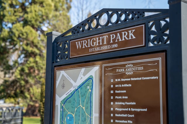 Wright Park established 1890 monument sign with park map and amenities list.