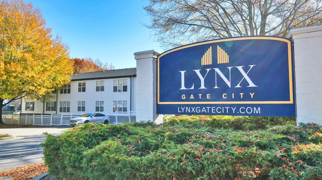 Lynx Gate City monument sign with building in background