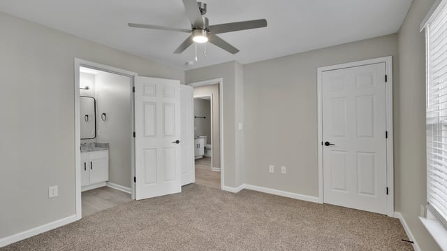 Bedroom with ceiling fan and doors to bathroom and closet
