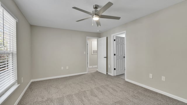 Bedroom with ceiling fan and a window.