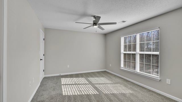 Empty bedroom with a ceiling fan and a large window with blinds.