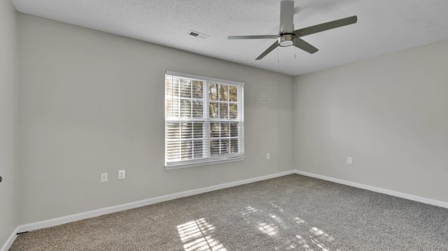 Bedroom with carpet, ceiling fan, and blinds on the window.