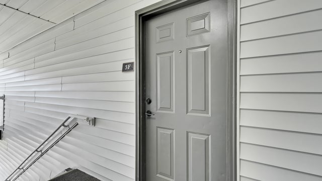 Exterior apartment building entrance door with unit number 3F.