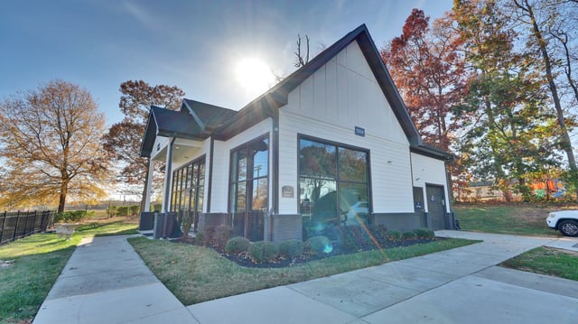 Modern building with large windows and modern landscaping.