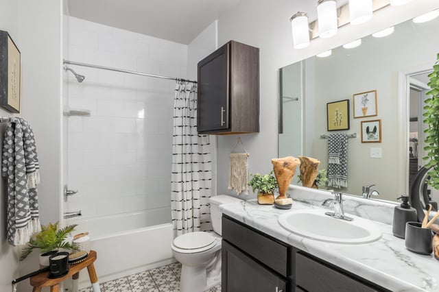 Bathroom with a shower/tub combo, vanity, and toilet.
