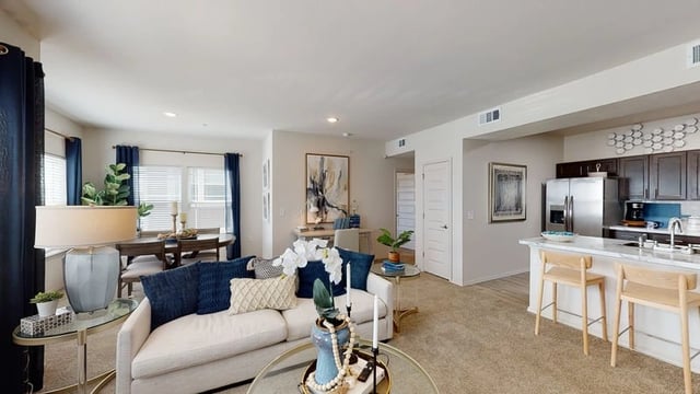 A modern building with a central entrance and a sculpture in front.