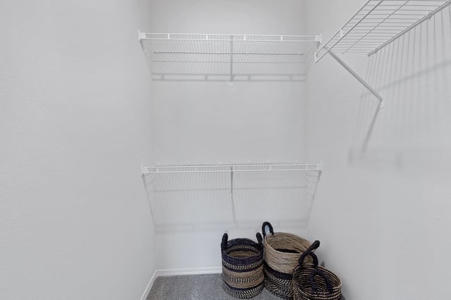 Empty closet with wire shelving and decorative baskets
