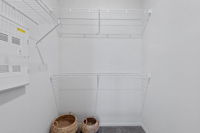 Interior view of a closet with shelving and baskets.