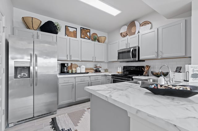 Modern bathroom with stainless steel appliances and marble counter