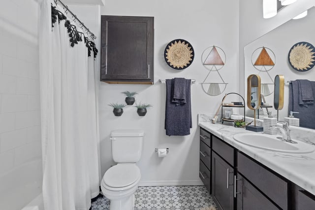 Modern bathroom with a bathtub, toilet, and stylish decor.