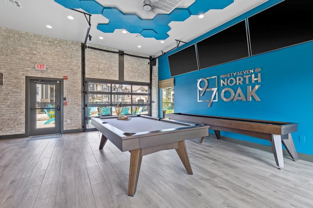 Game room with pool table, shuffleboard, and lounge area at Ninety-Seven @ North Oak