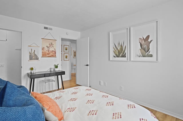 Bedroom with a desk and artwork.