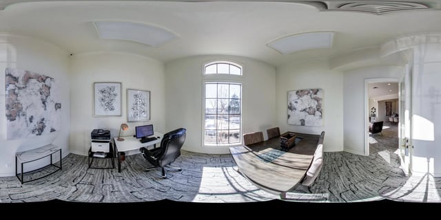 Home office and dining area with large windows and modern decor.