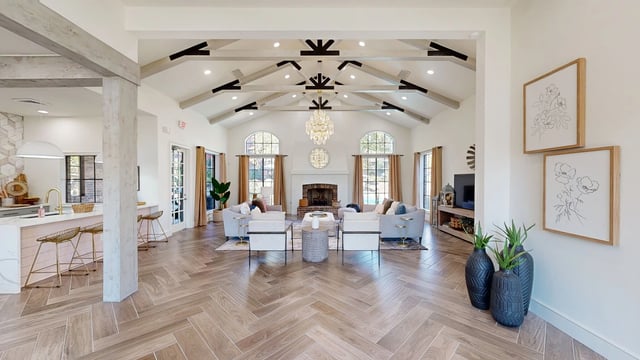 Spacious living area with fireplace and seating.