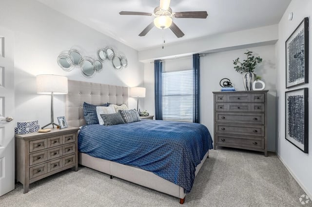 Bedroom with a king-sized bed, nightstands, and a dresser.