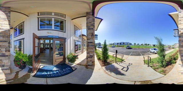 Artisan Crossing apartment building entrance and parking lot