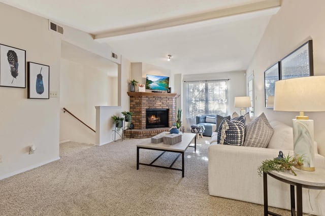 A living room with a fireplace and a couch.