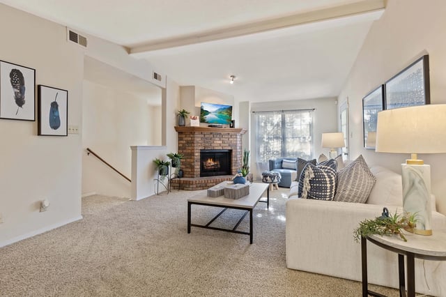 A living room with a fireplace and a couch.