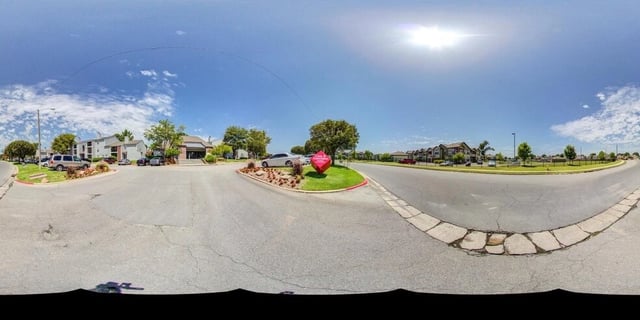 View of the apartment complex entrance and buildings.