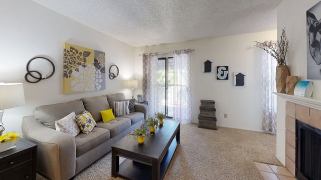 Living room with a couch, coffee table, and fireplace.