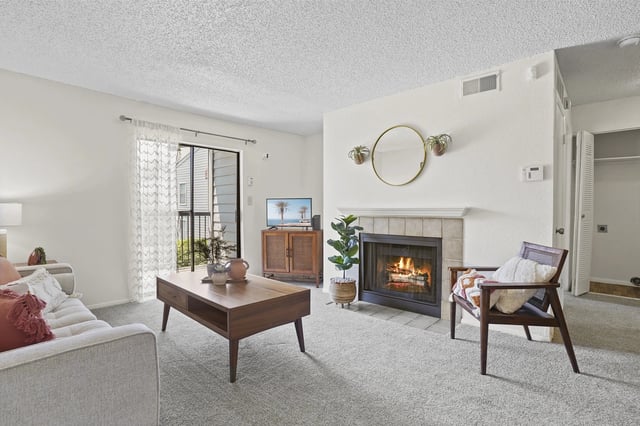 A living room with a fireplace and a couch.