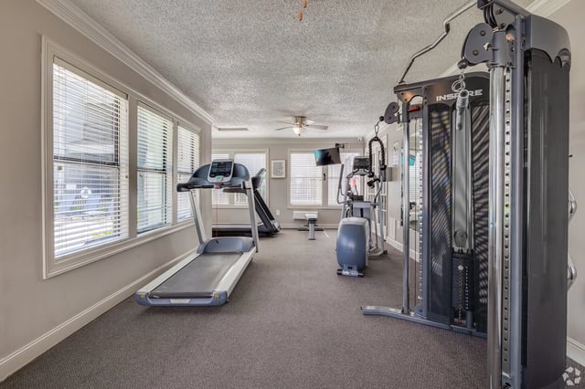 Fitness center with treadmills, elliptical, and weight machine.