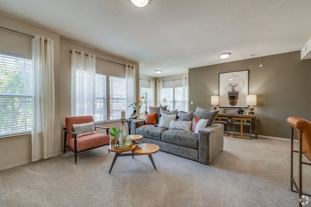 A living room with a gray sofa, an accent chair, and a coffee table.
