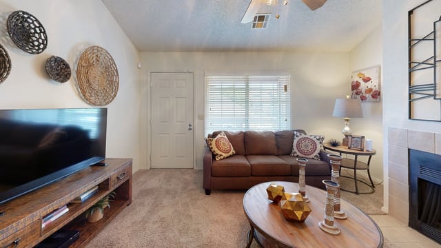 Living room with a brown sofa, coffee table, and entertainment center.