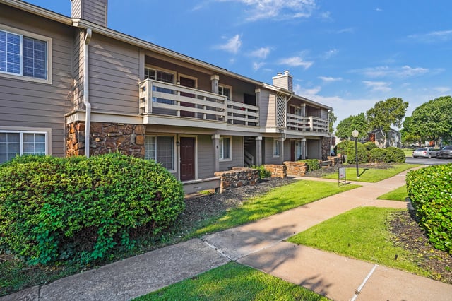 Exterior view of apartment buildings with balconies and walkways.