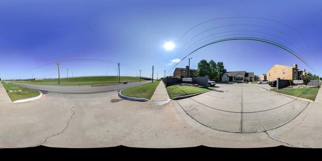 Exterior view of a multifamily property with buildings, landscaping, and signage.