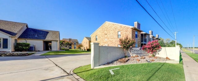 Cimarron Trace Apartments monument sign with landscaping.