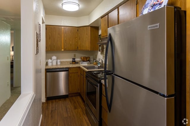 Kitchen with stainless steel appliances and wood cabinets.