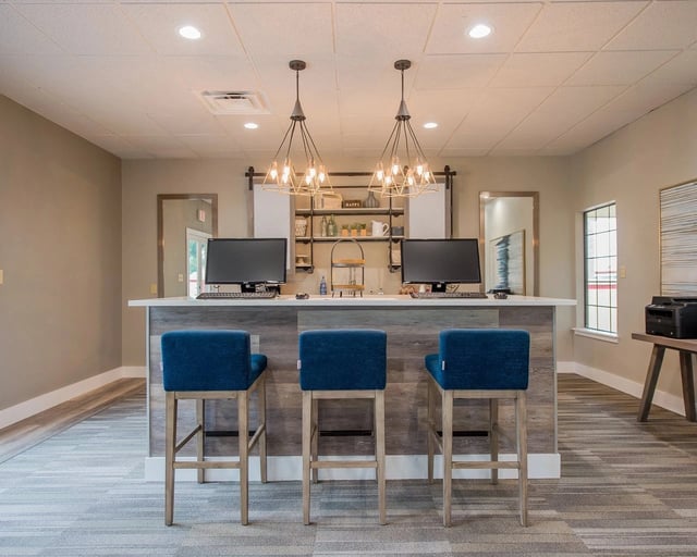 Business center with computers and seating.