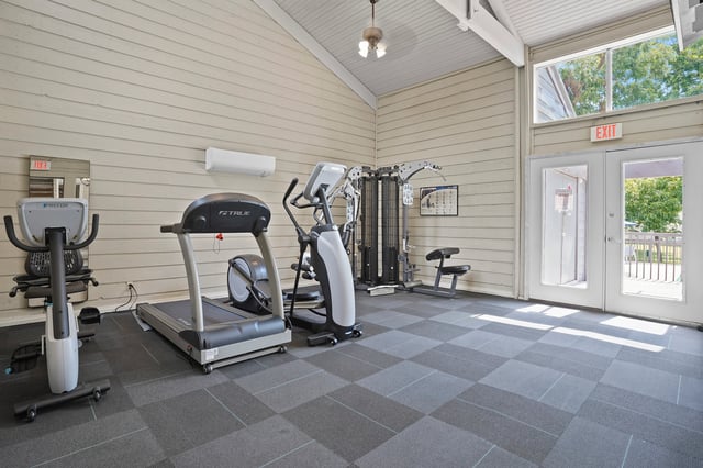 Fitness center with treadmills, elliptical, and weight machine.