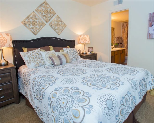 Bedroom with a king-size bed, nightstands, and lamps.