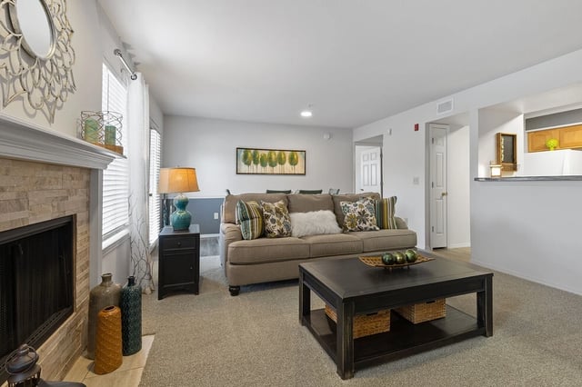 Living room with a fireplace, sofa, and coffee table.