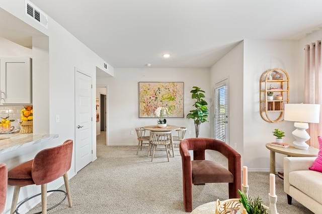 Stylish living and dining area with plush seating, a round dining table, and modern decor.