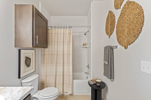 Modern bathroom with toilet, shower, and vanity
