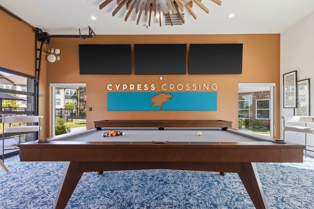 Cypress Crossing community room with pool table and TVs